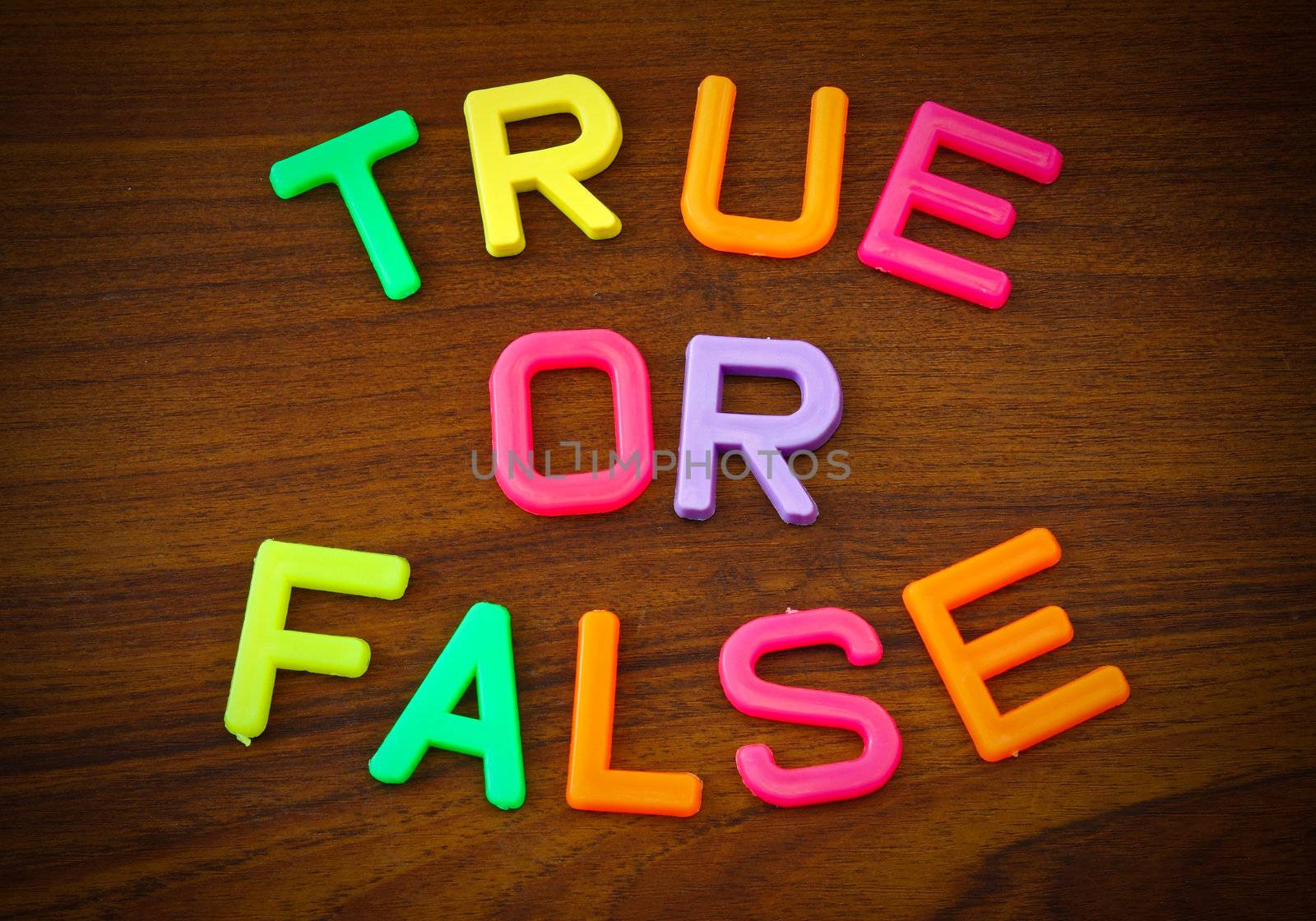 True or false in colorful toy letters on wood background