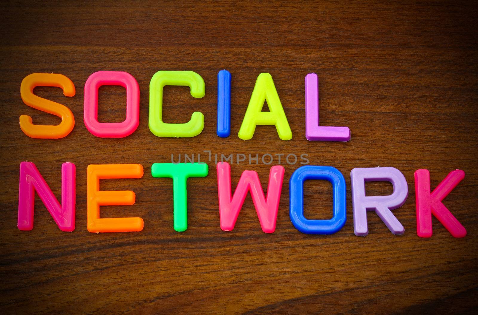 Social network in colorful toy letters on wood background by nuchylee