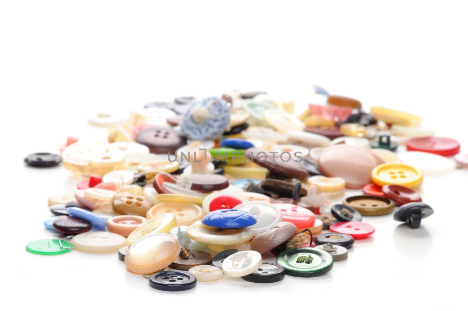 Collection of old discarded buttons on a white background.