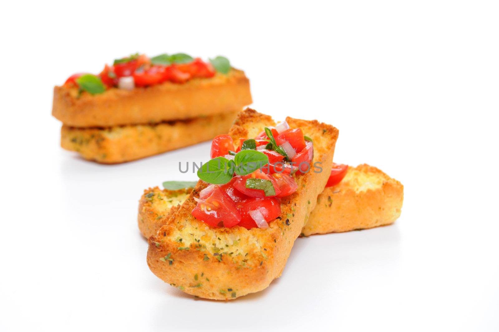 Bruschetta with tomato and fresh herbs on a white background.