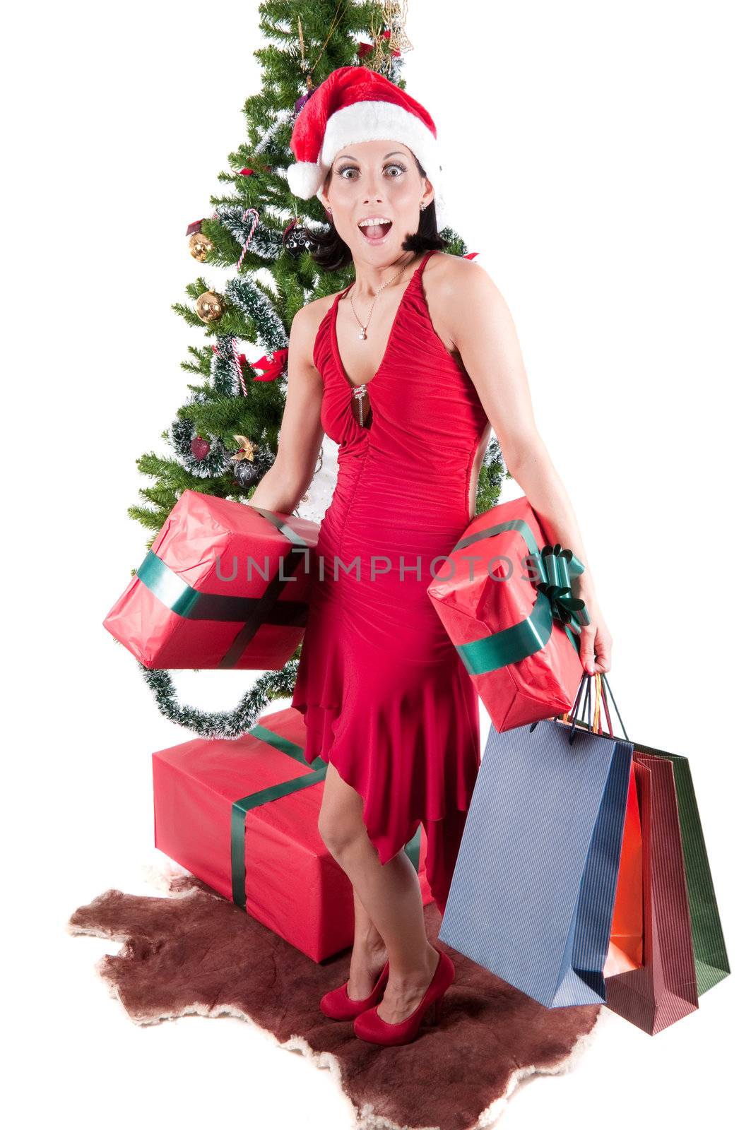 Happy woman with Christmas presents and tree isolated on white