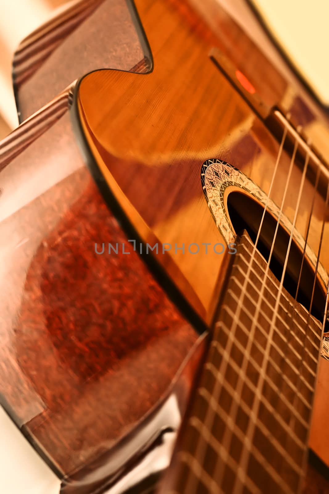 Polished surface of the body acoustic guitar with a neck and strings