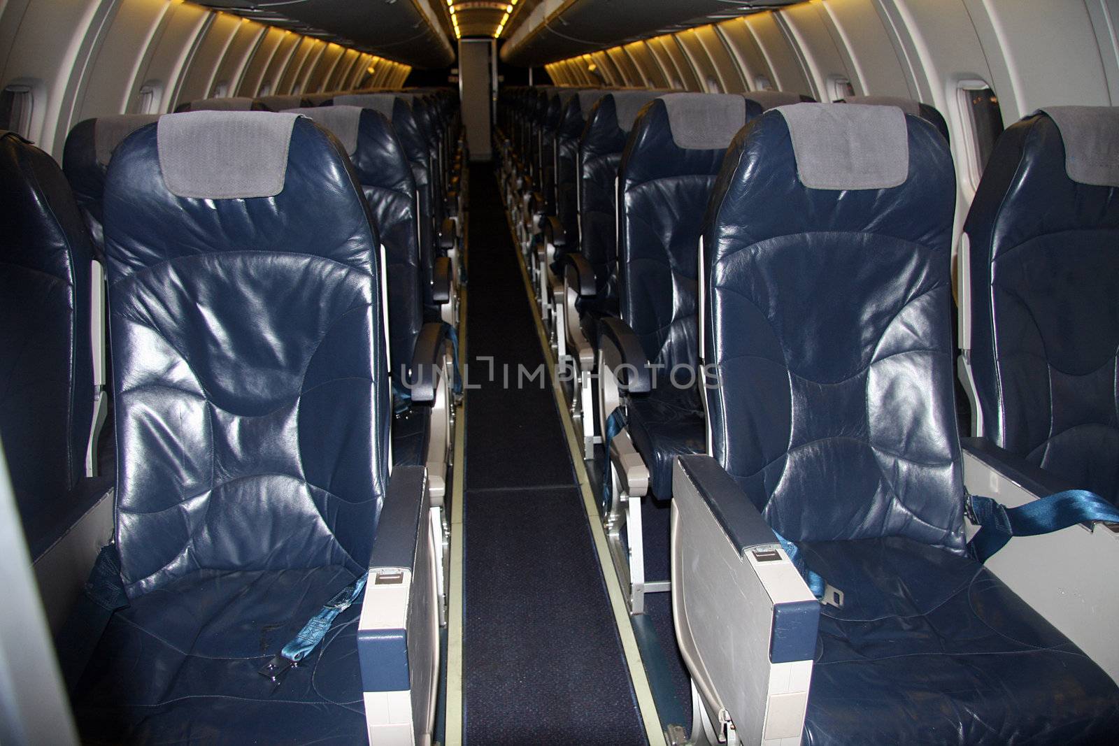 Inside of a commercial airplane with empty seats