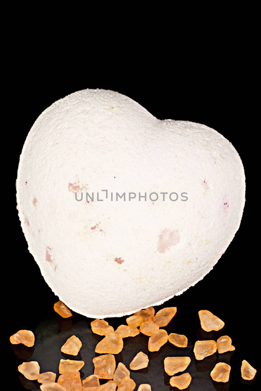 Bath soap in the form of the heart with a bath salts  on a black background.