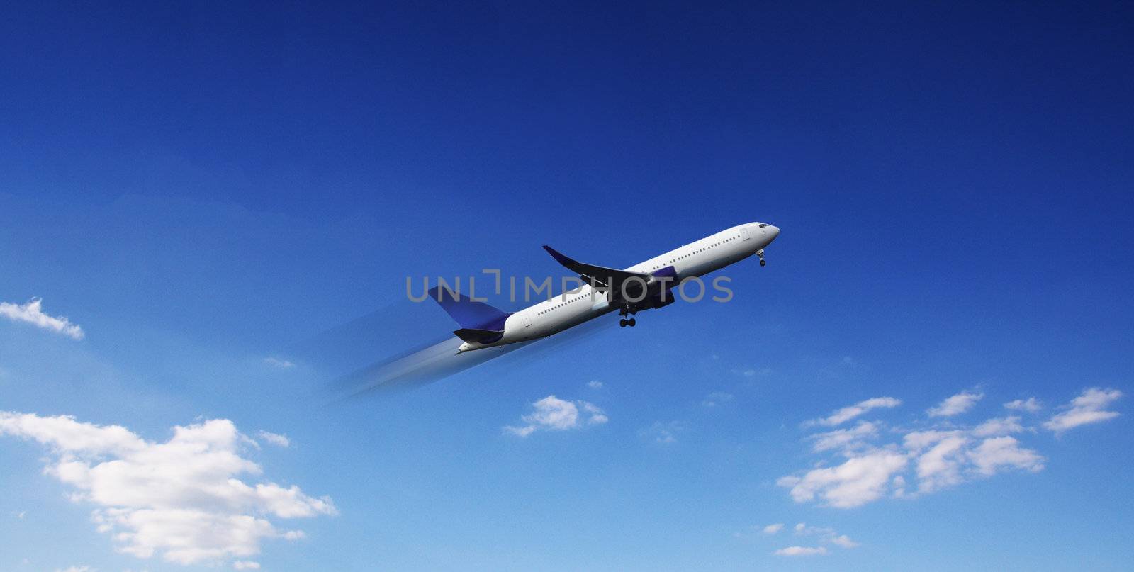 Aircraft in flight over the blue clouds 