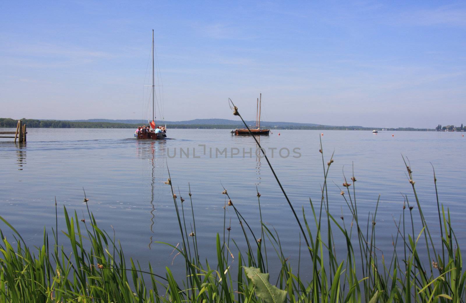 boats on lake steinhuder meerwith reed in the front, lower saxony, germany