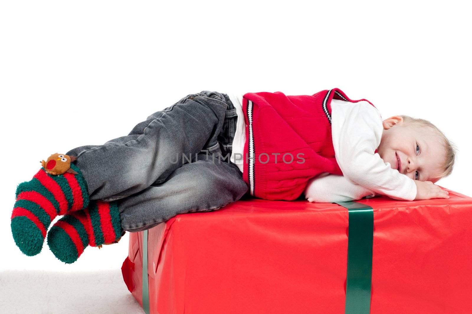 Shot of christmas toddler with presents isolated on white