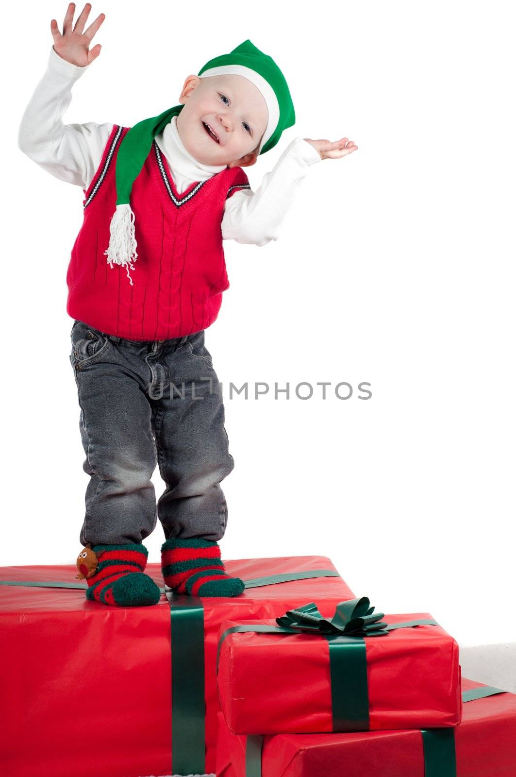 Shot of christmas toddler with presents isolated on white