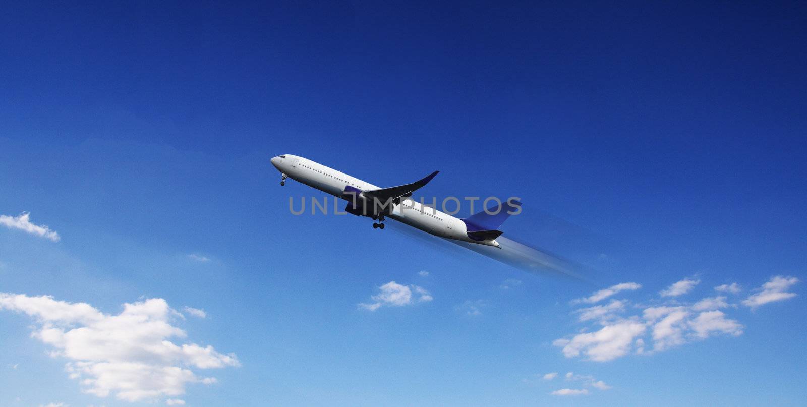 Aircraft in flight over the blue clouds 