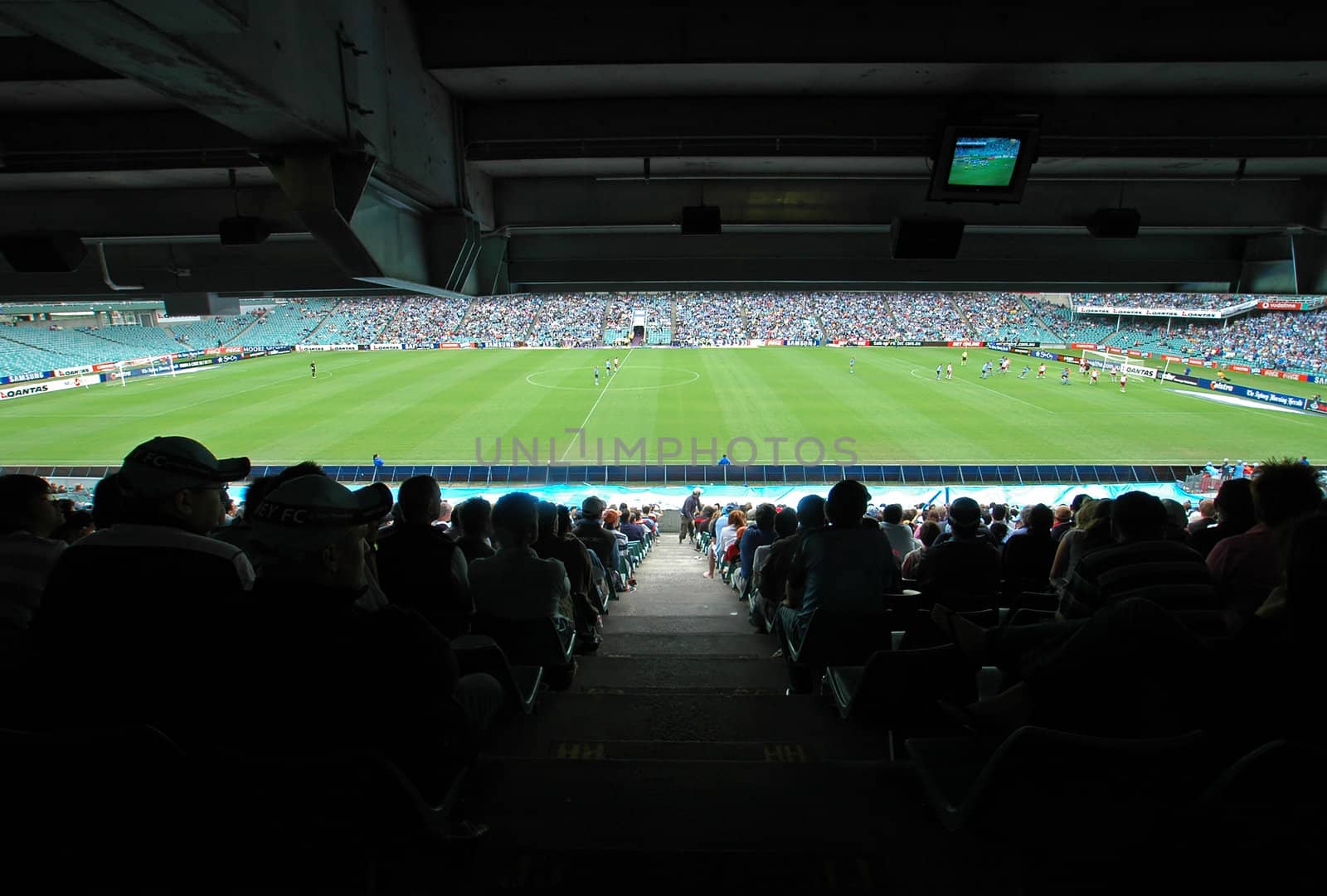 soccer stadium, soccer stadium, green playfield, players, fans in shadow