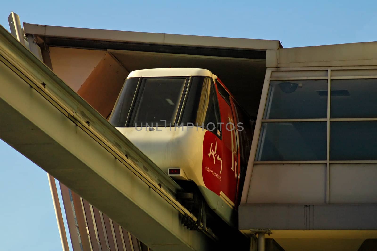 sydney monorail, red/white train leaving station above ground
