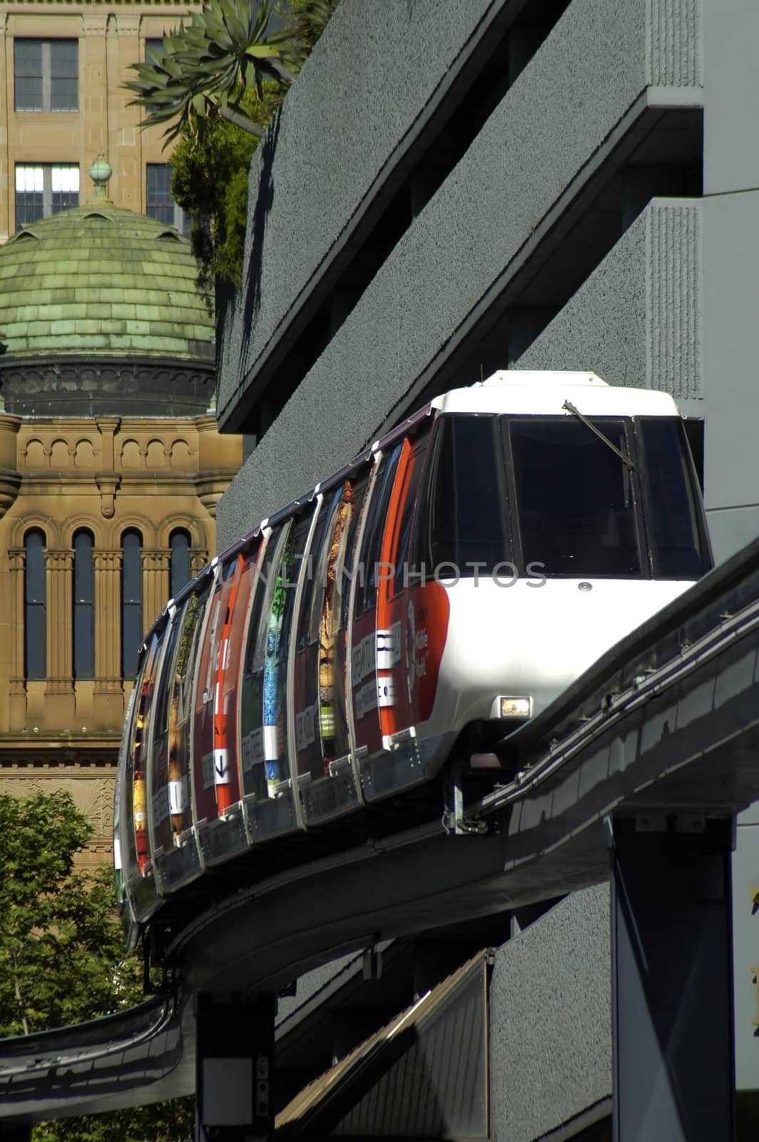 sydney monorail, train on single rail, buildings in background, telephoto