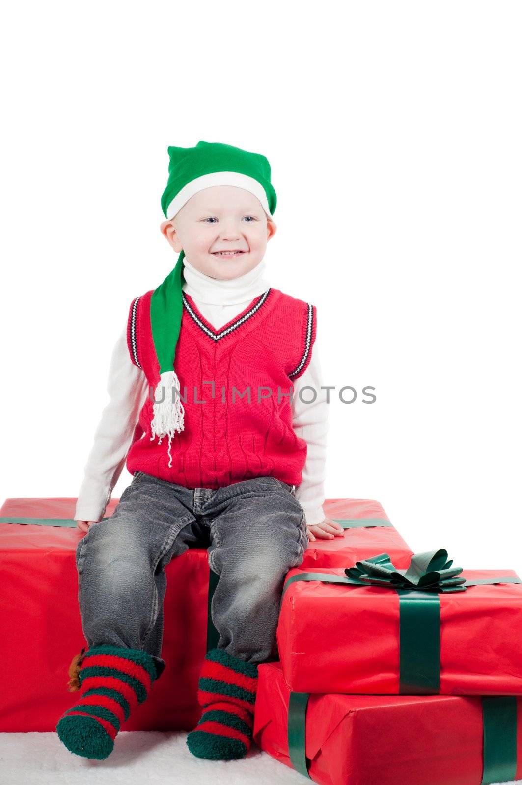 Shot of christmas toddler with presents isolated on white