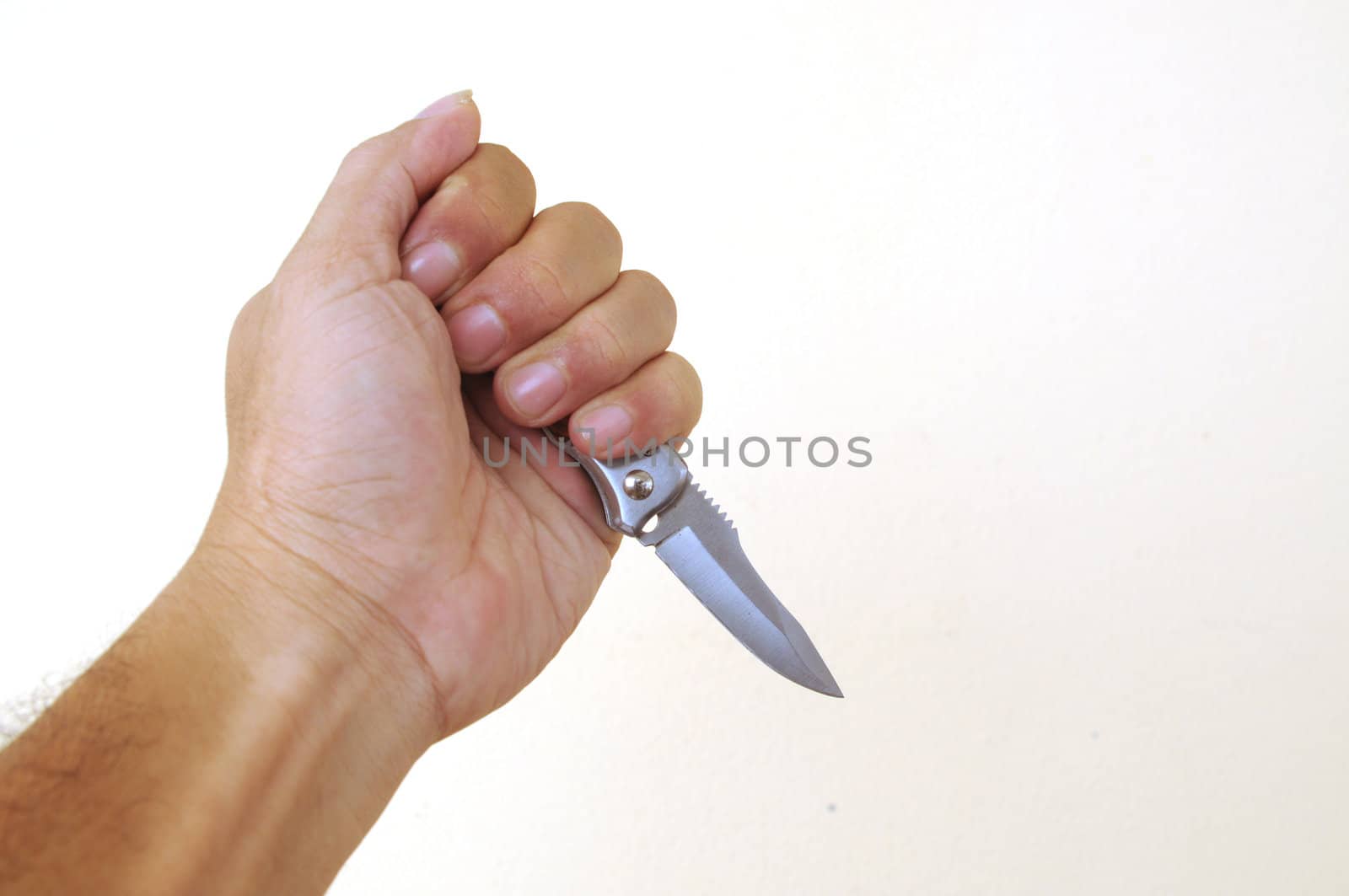 Hand holding a knife isolated on white background