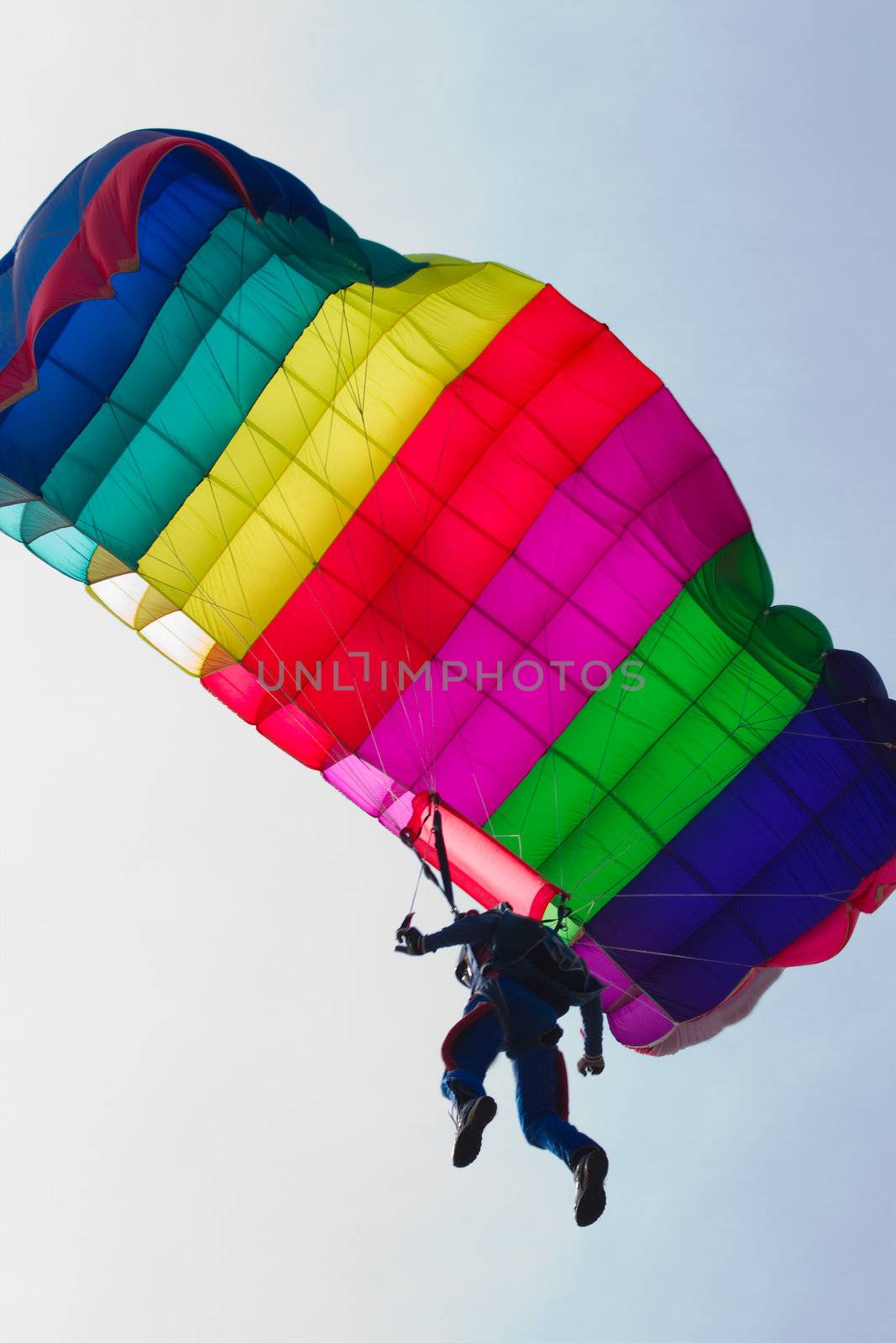 Parachutist demonstrates jumping from airplane by Colette