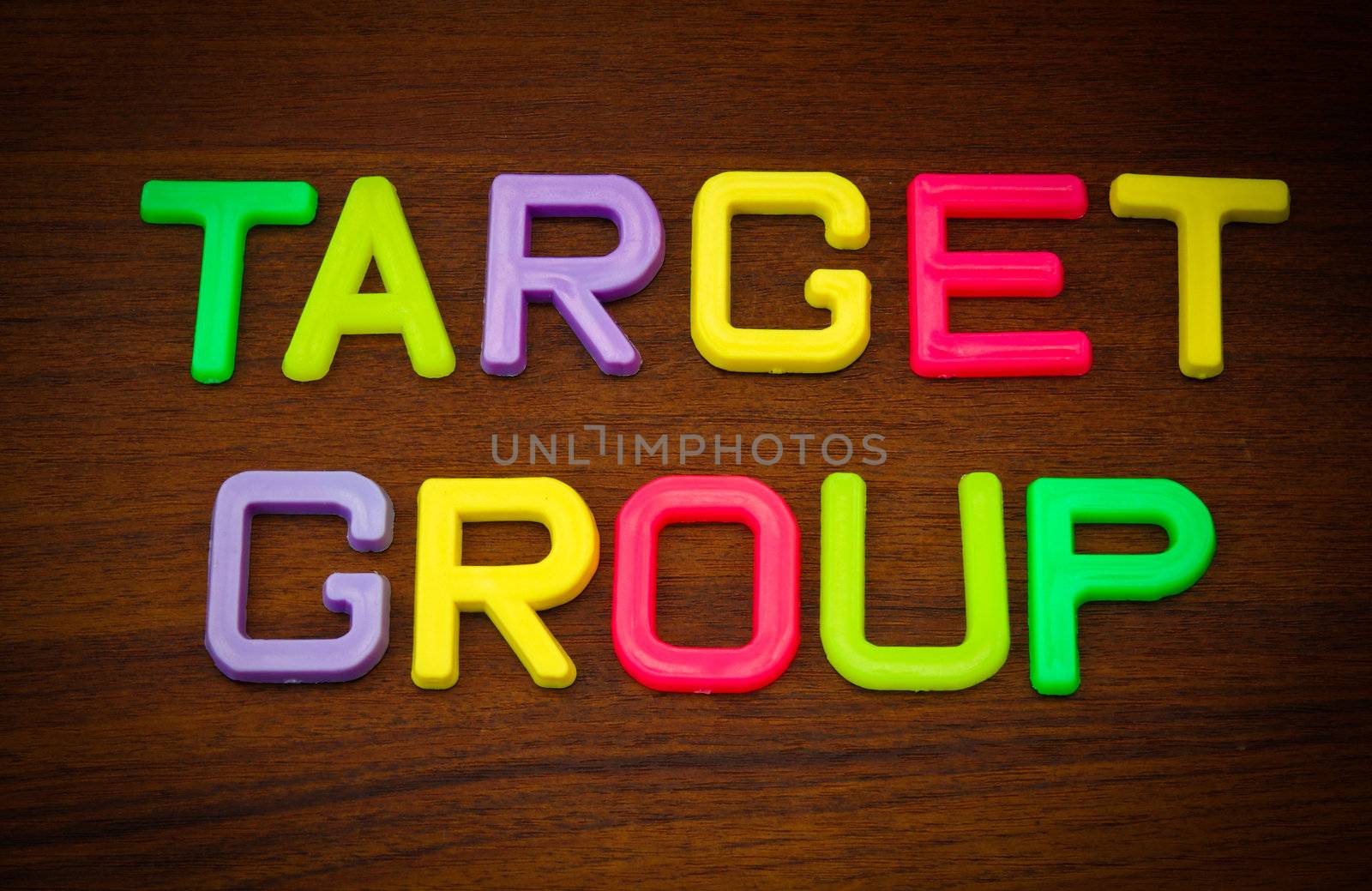 Target group in colorful toy letters on wood background  by nuchylee