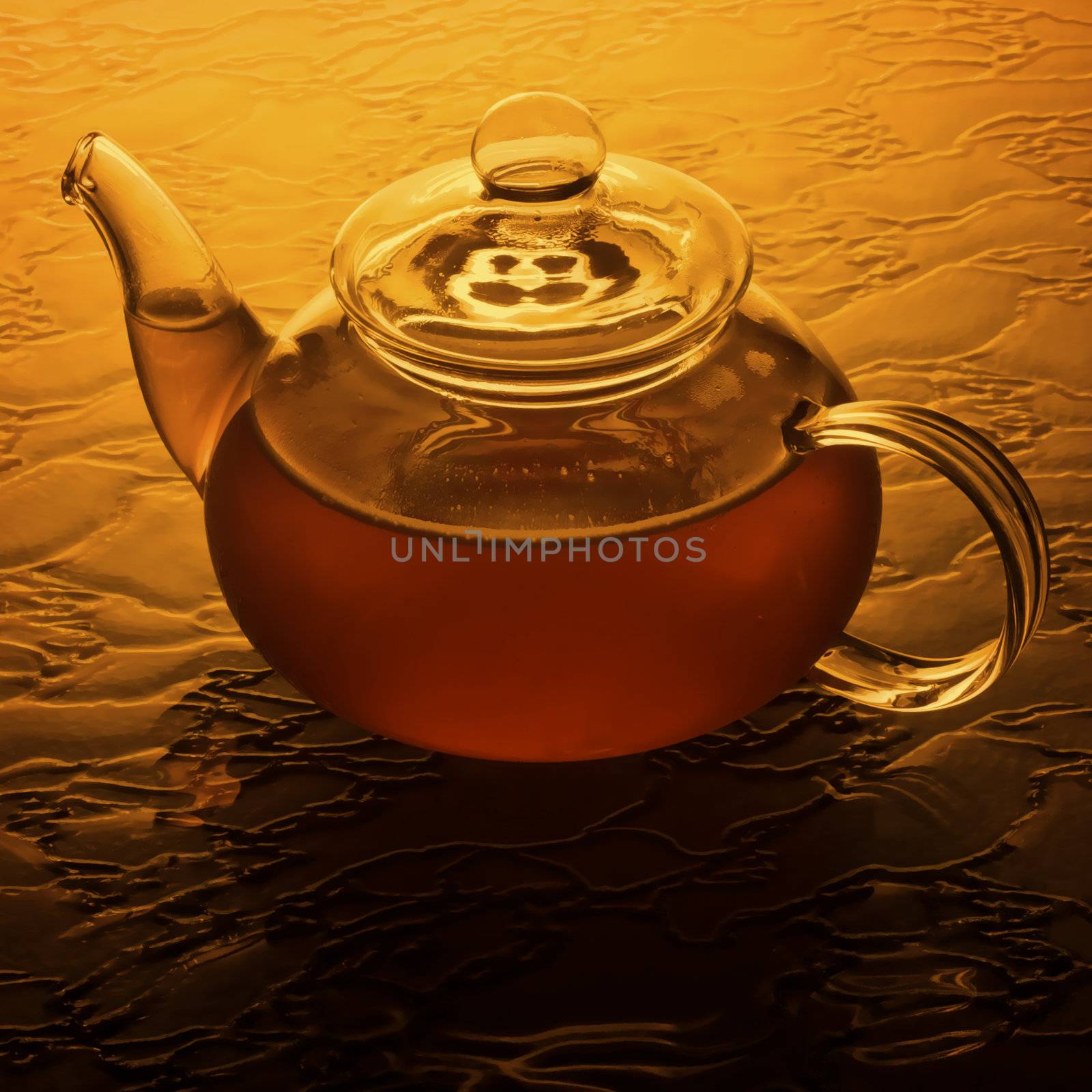 Amber glass teapot brewing in morning light