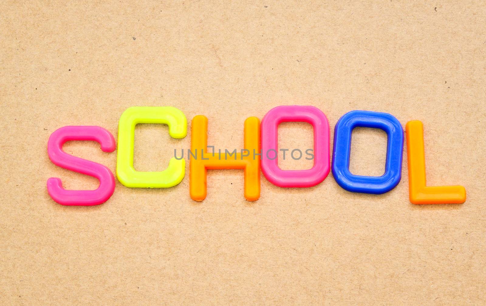 School in colorful toy letters on paper background