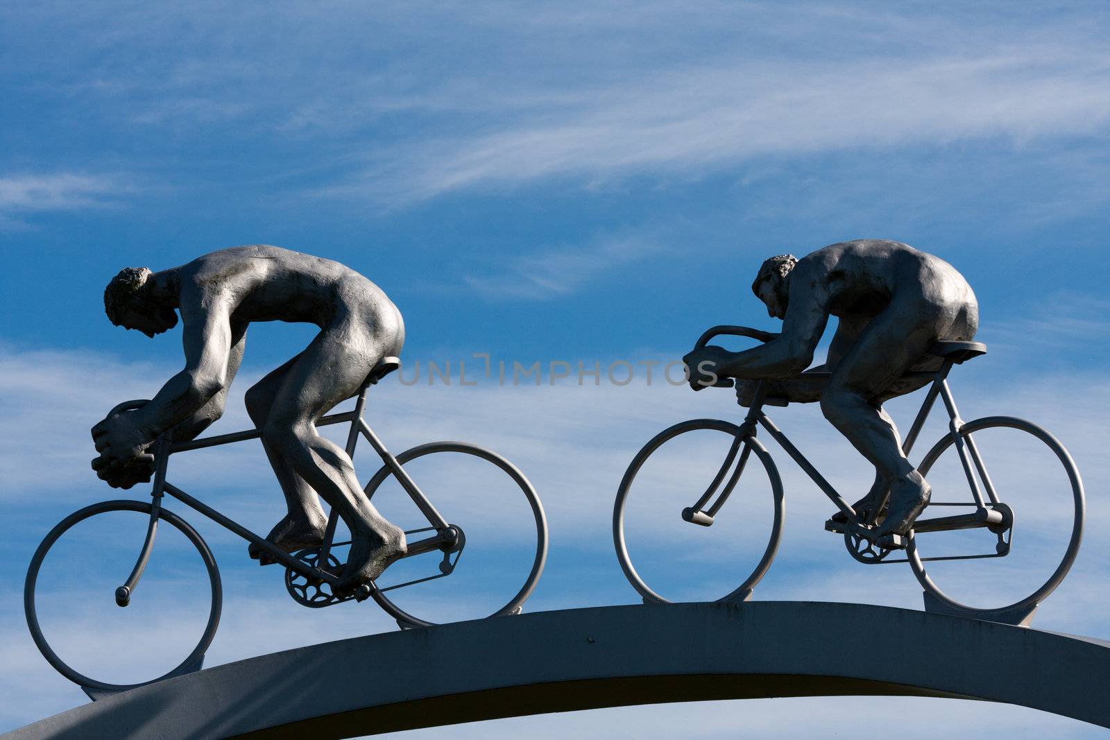 Two cyclists in full effort, detail of a sculpture