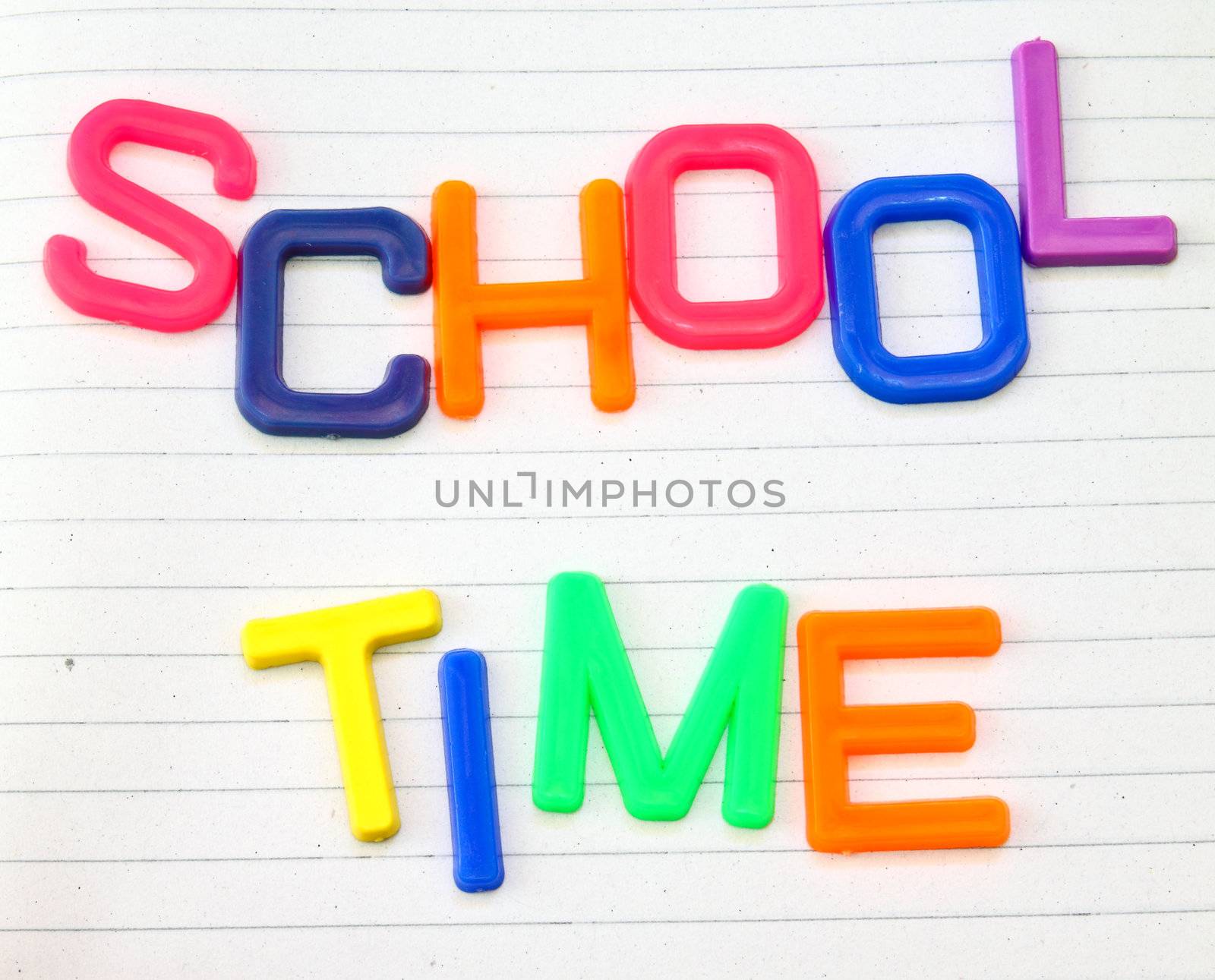 School time in colorful toy letters on lined paper background  by nuchylee
