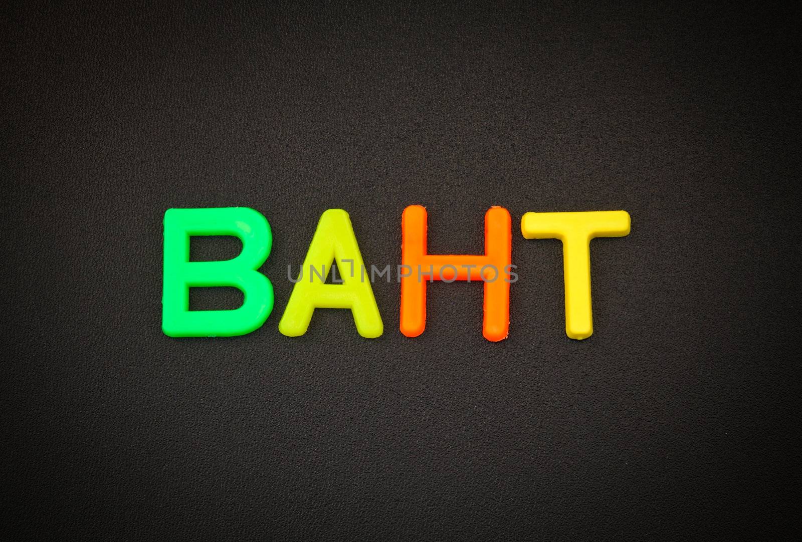 Baht in colorful toy letters on black background