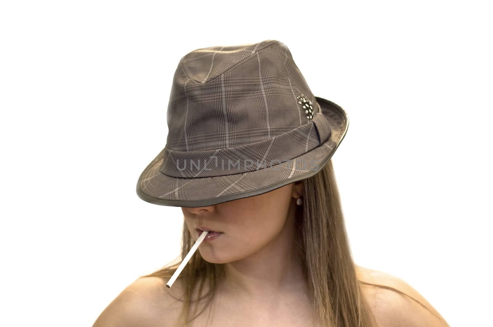 Young woman in a hat with a cigarette in his mouth. Close-up, studio shot, white background.