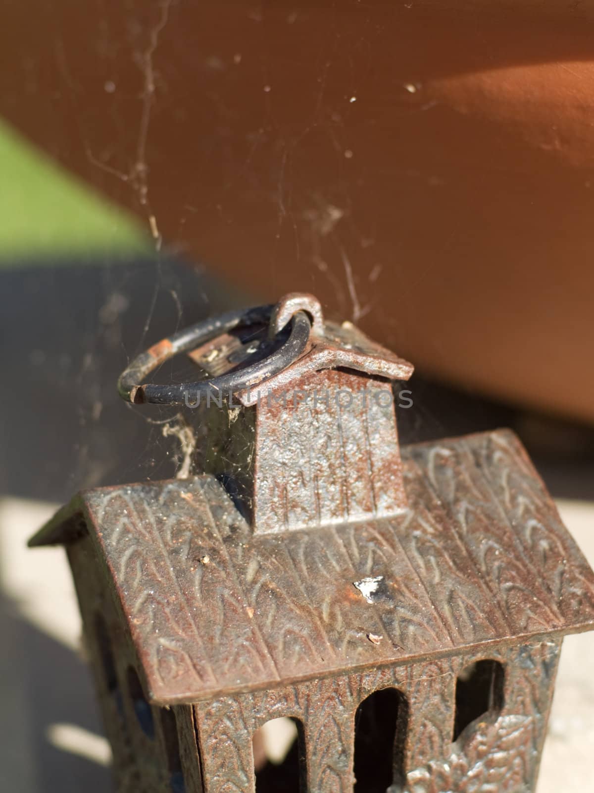 Rusty birdhouse with cobwebs, forgotten and very old.