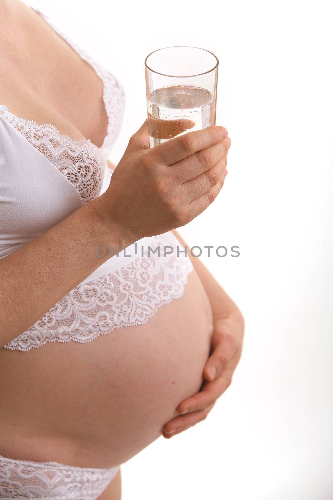 expectant mother with glass of mineral water