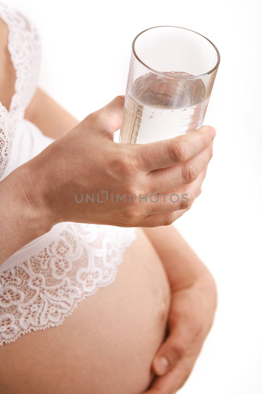 expectant mother with glass of mineral water