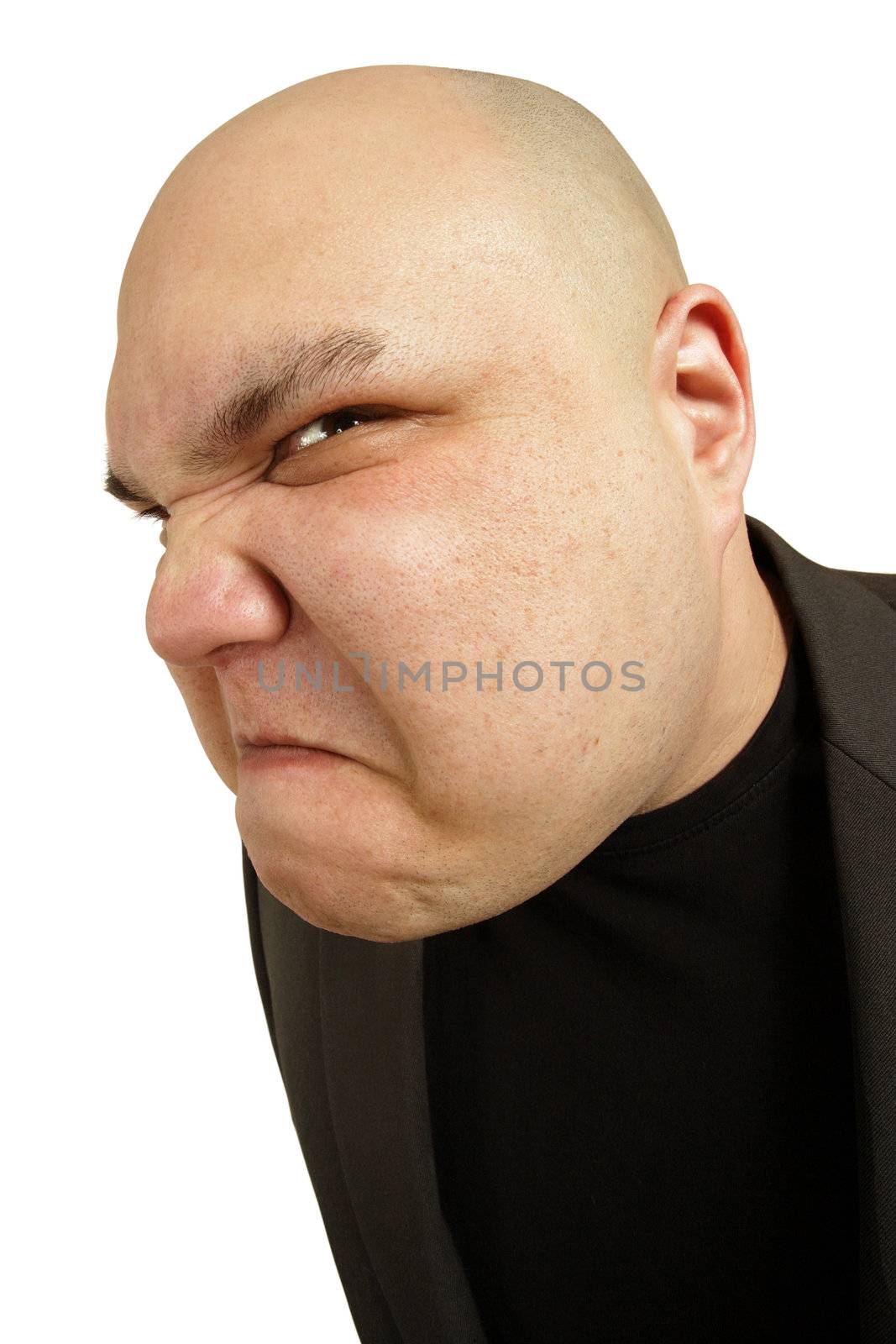 A bald man with an angry threatening sneer or disgusted look on his face.
