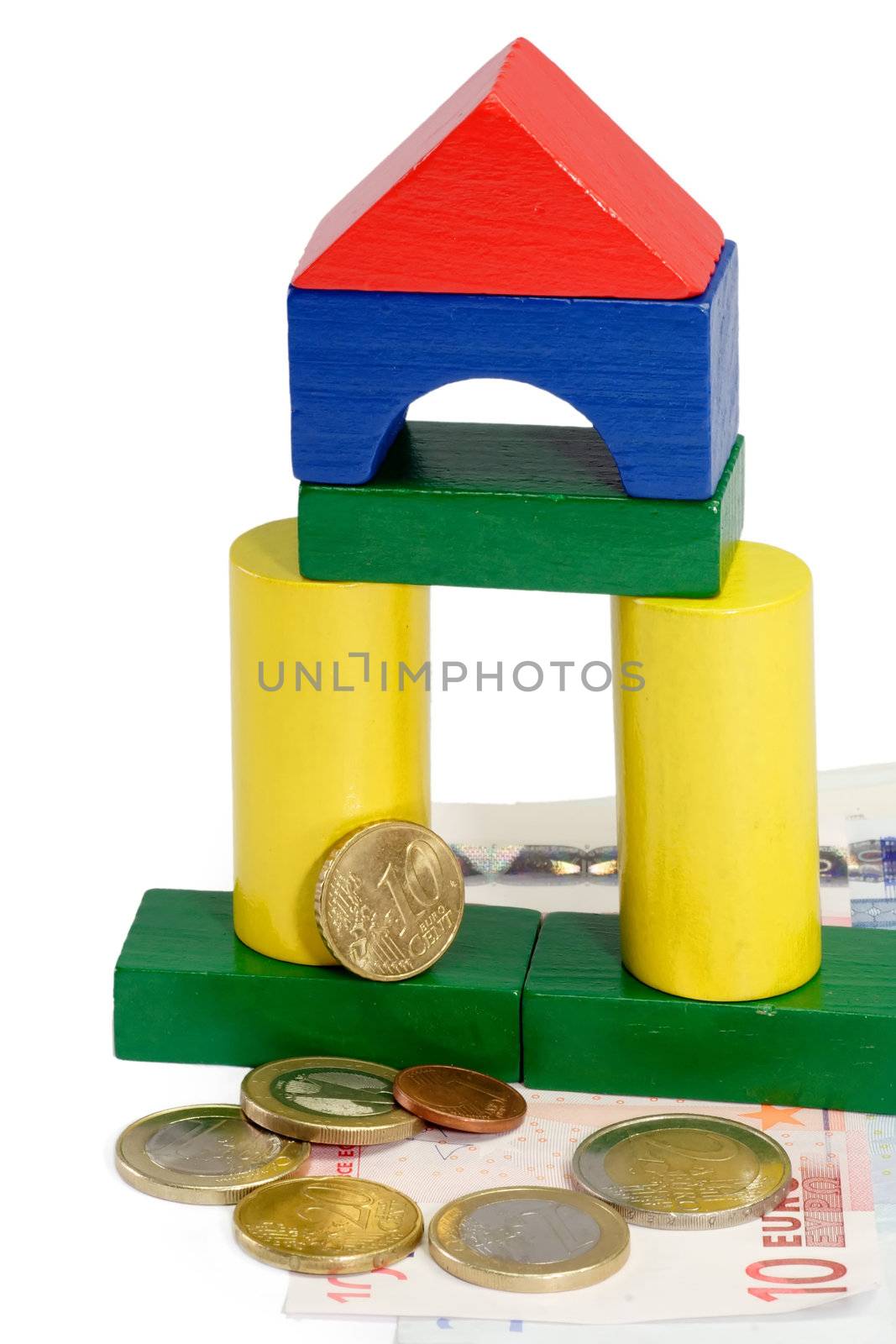 Colorful toy brick house with Euro banknotes
