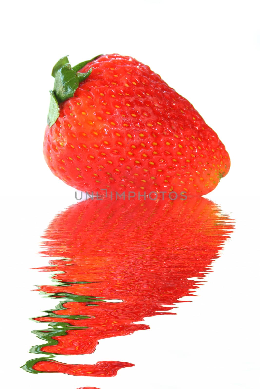 A fresh strawberry isolated on a white background with a reflection in water.