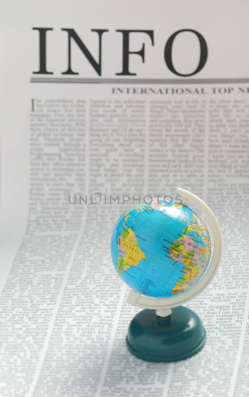 small globe on a  newspaper page. info media