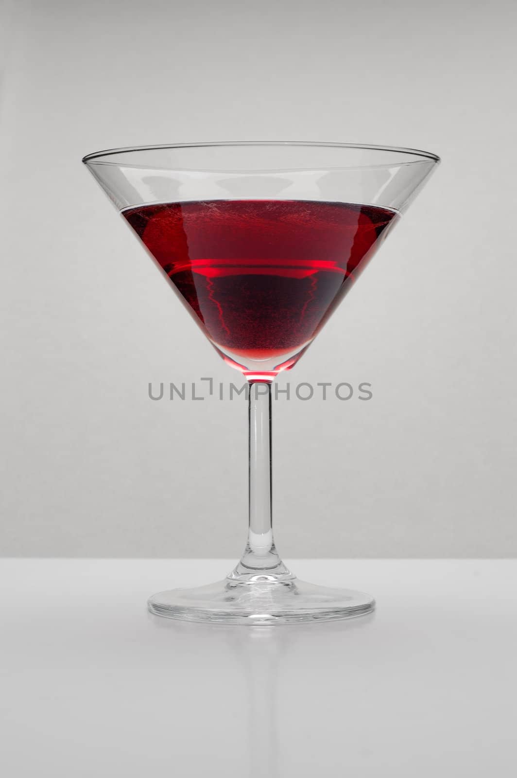 red beverage in a cocktail glass