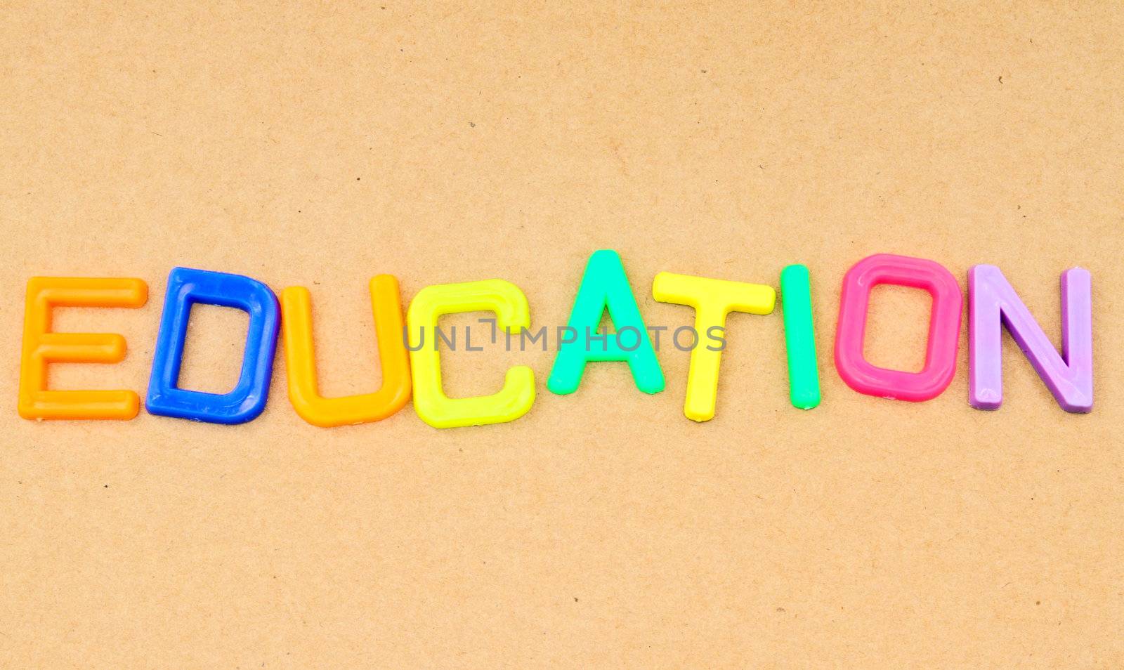 Education in colorful toy letters on paper background  by nuchylee