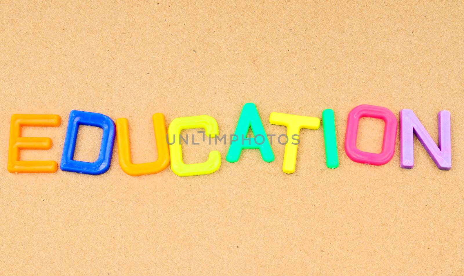 Education in colorful toy letters on paper background