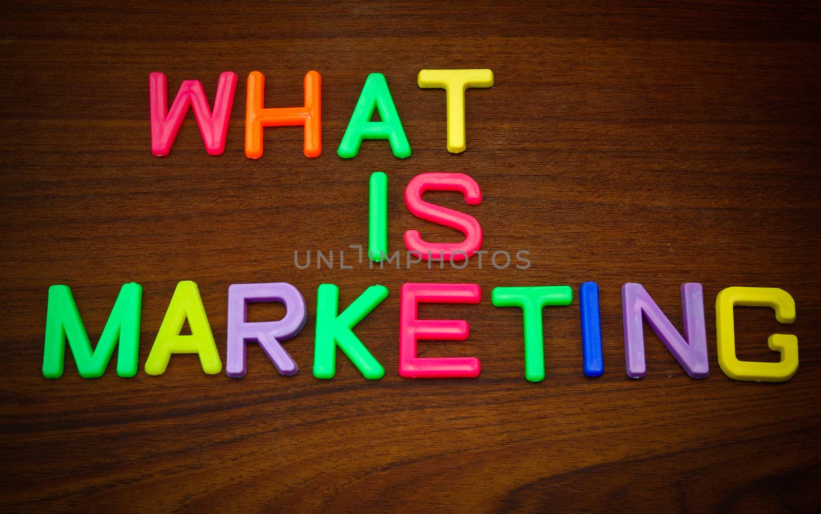 What is marketing in colorful toy letters on wood background