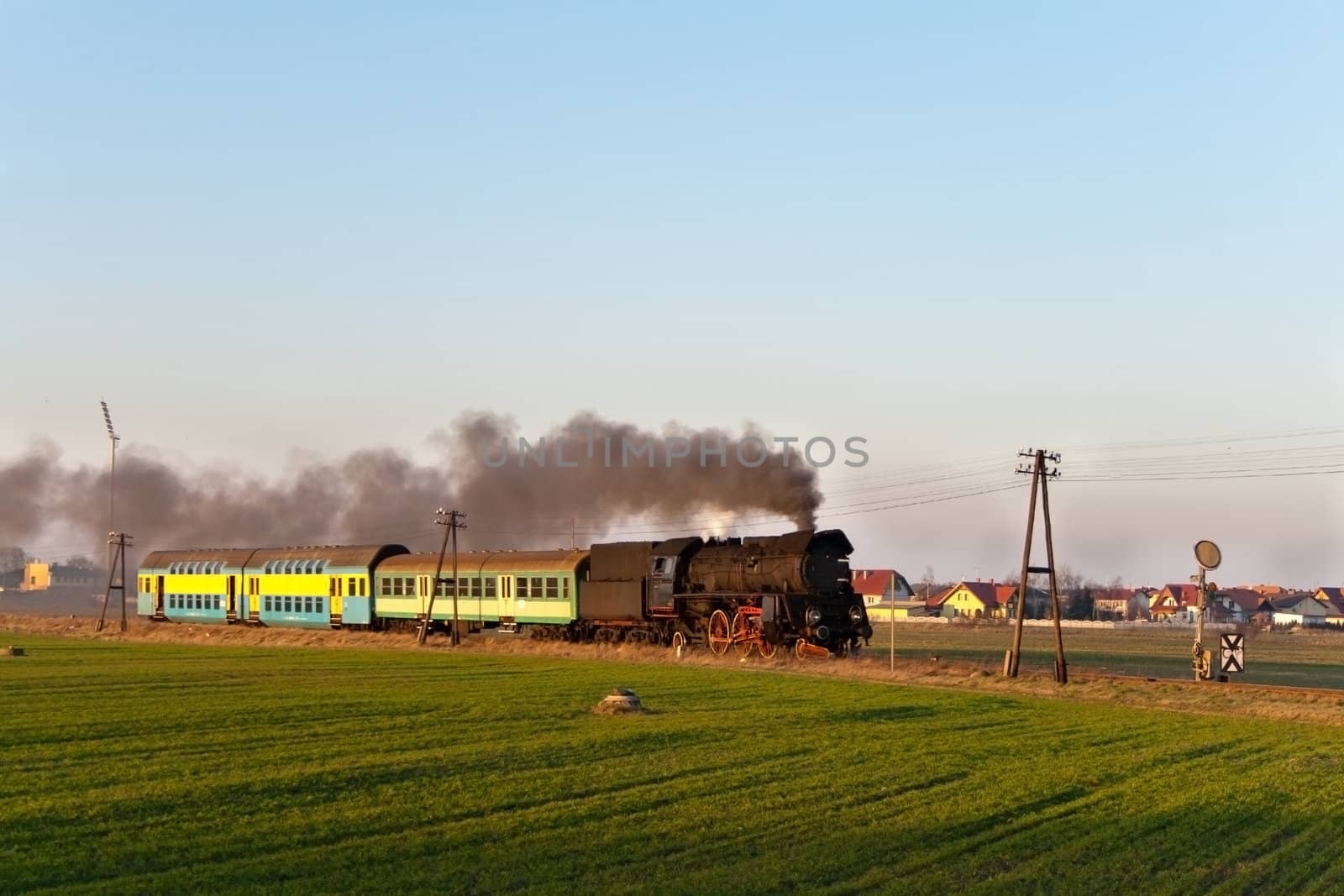 Vintage steam train passing through countryside
