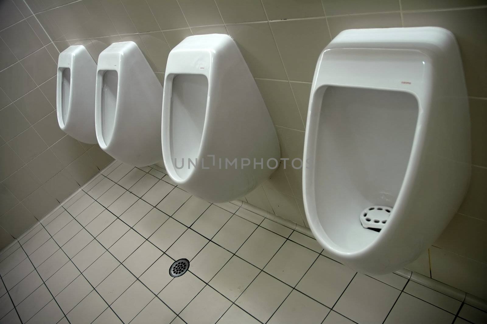 four mans toilets, airport restroom, all white