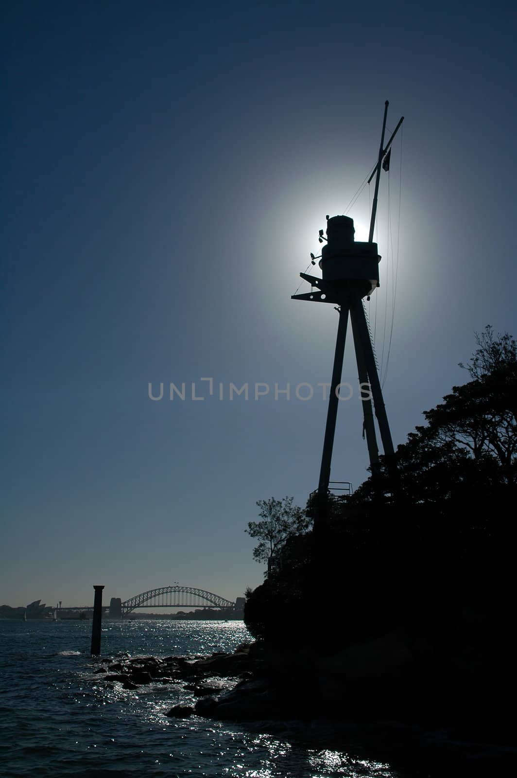 silhouette of mast memorial in sydney, opera house and harbour bridge in background