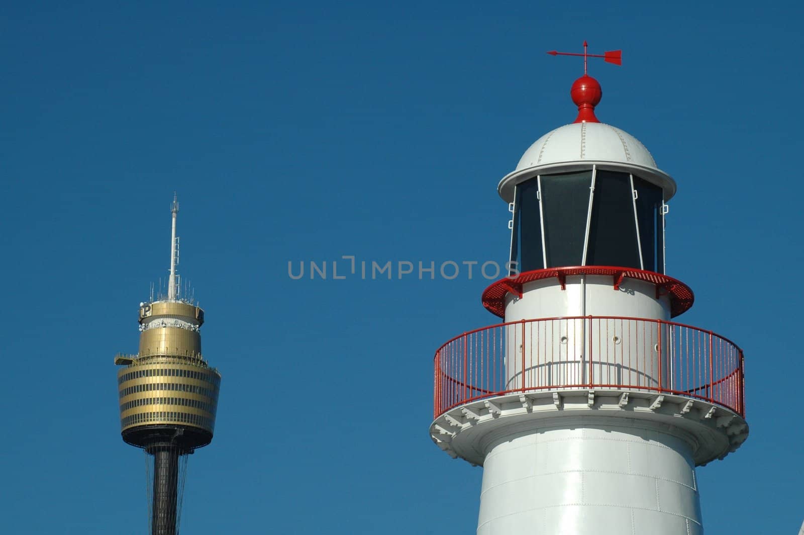 white lighthouse with red parts and sydney tower, blue sky, simple photo