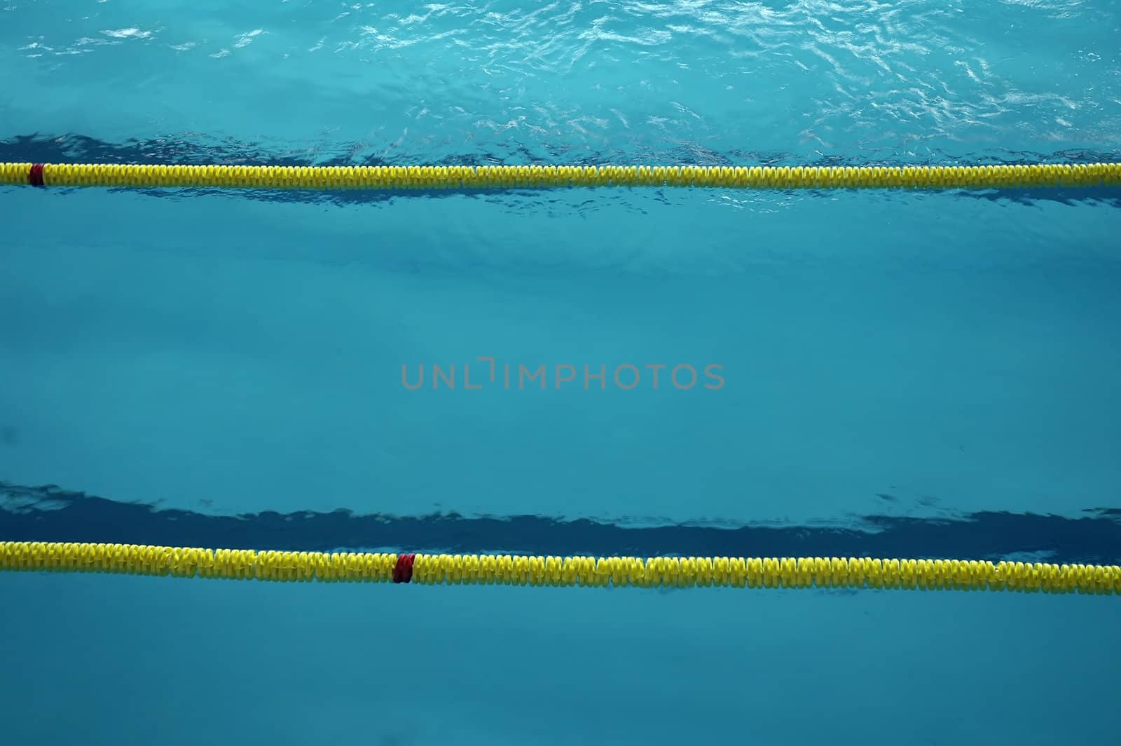 empty swimming pool detail, three swimming lanes divided with plastic barrier, photo taken in Humenn� - Slovakia