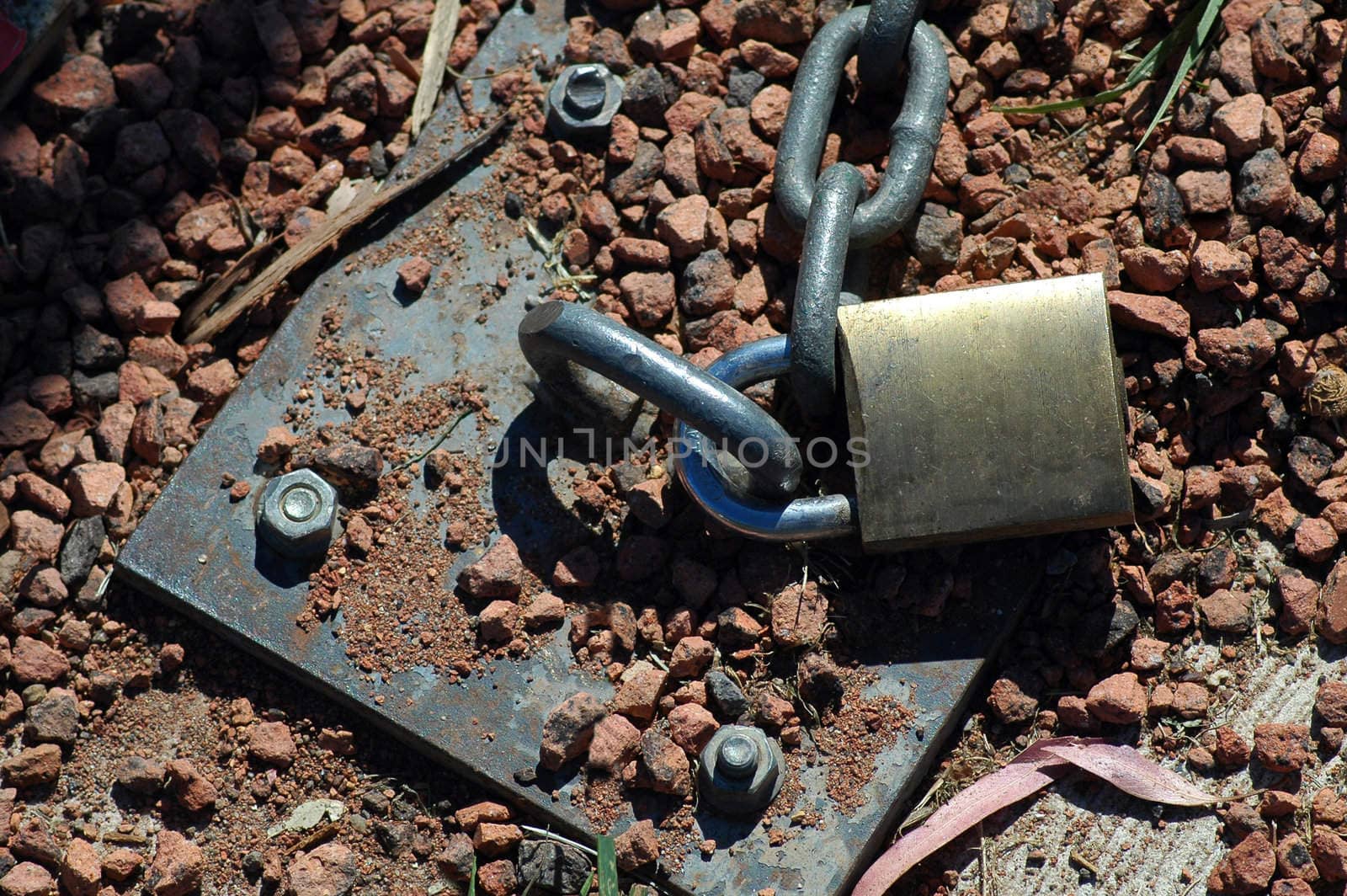 steel chain locked into gravel ground, hot weather