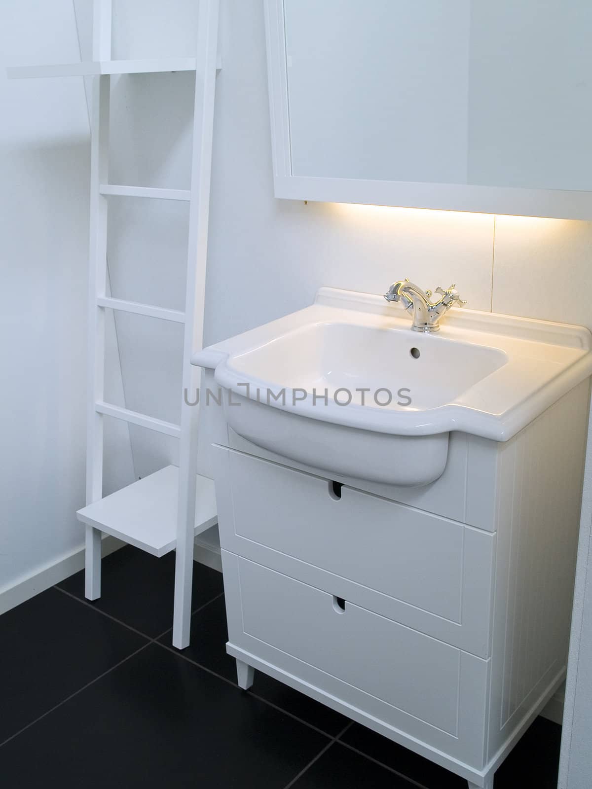 Details of a modern trendy contemporary designer bathroom in all white elements