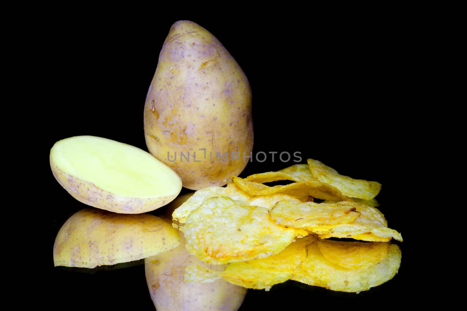 Potato and chips isolated on black background
