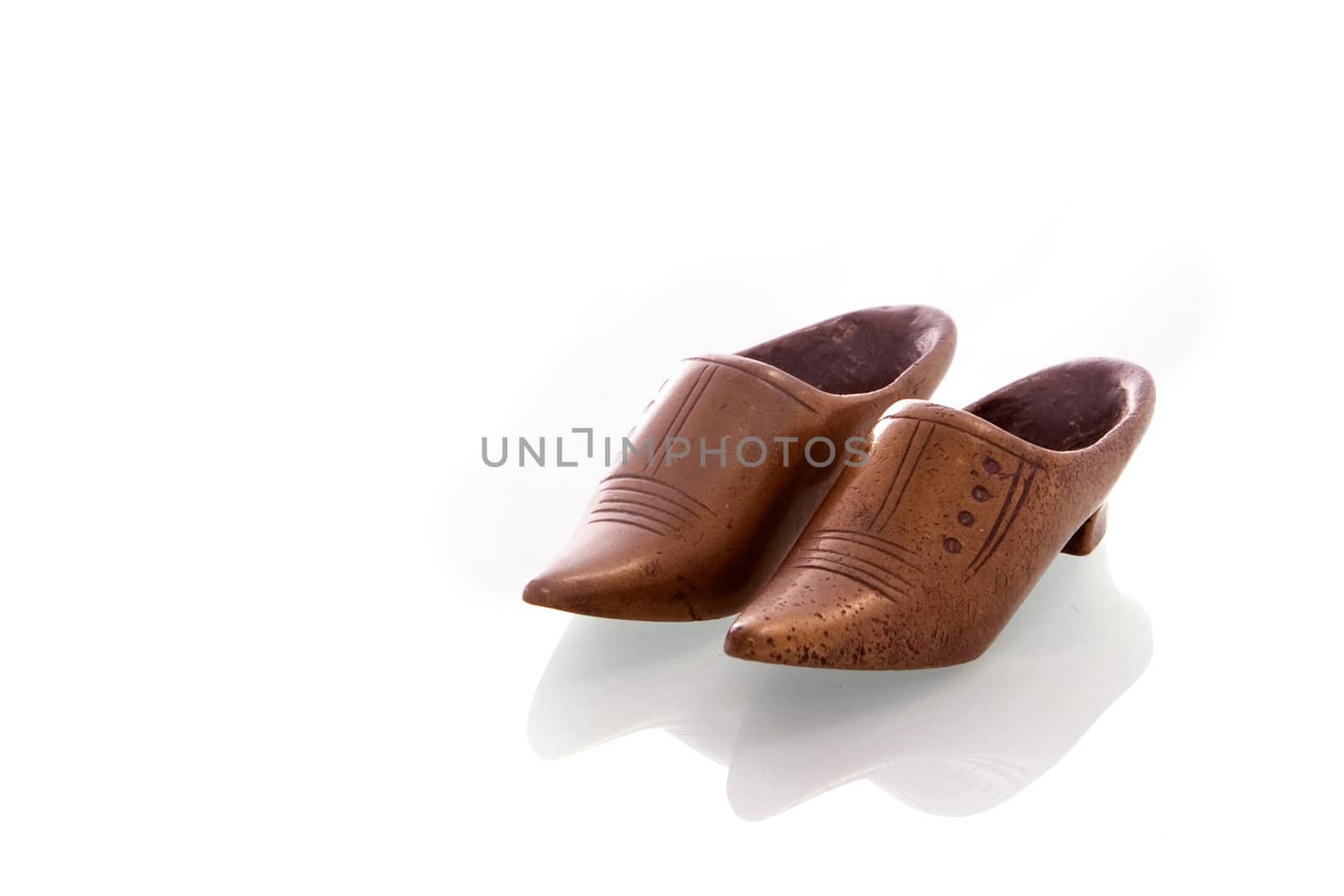 a pair of copper shoes on a white background