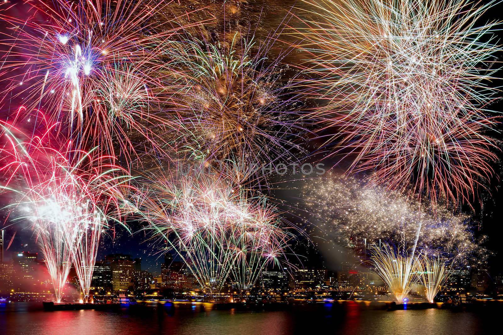 Fireworks Display Background with Waterfront City Skyline