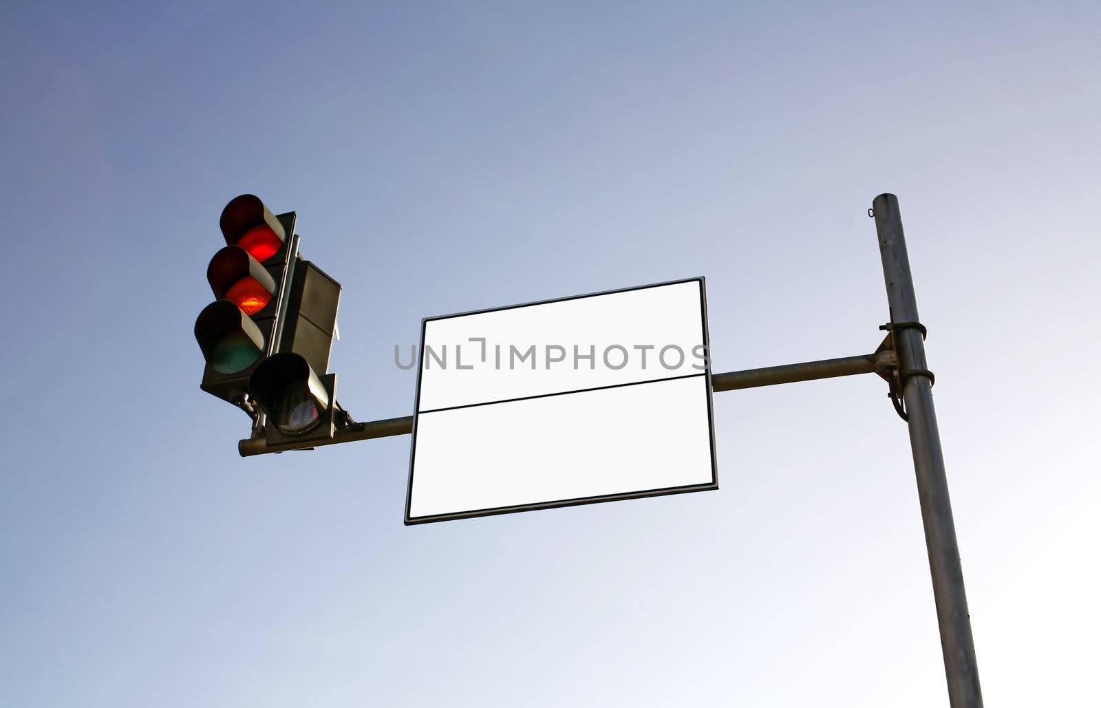 Empty road sign with semaphore against blue sky
