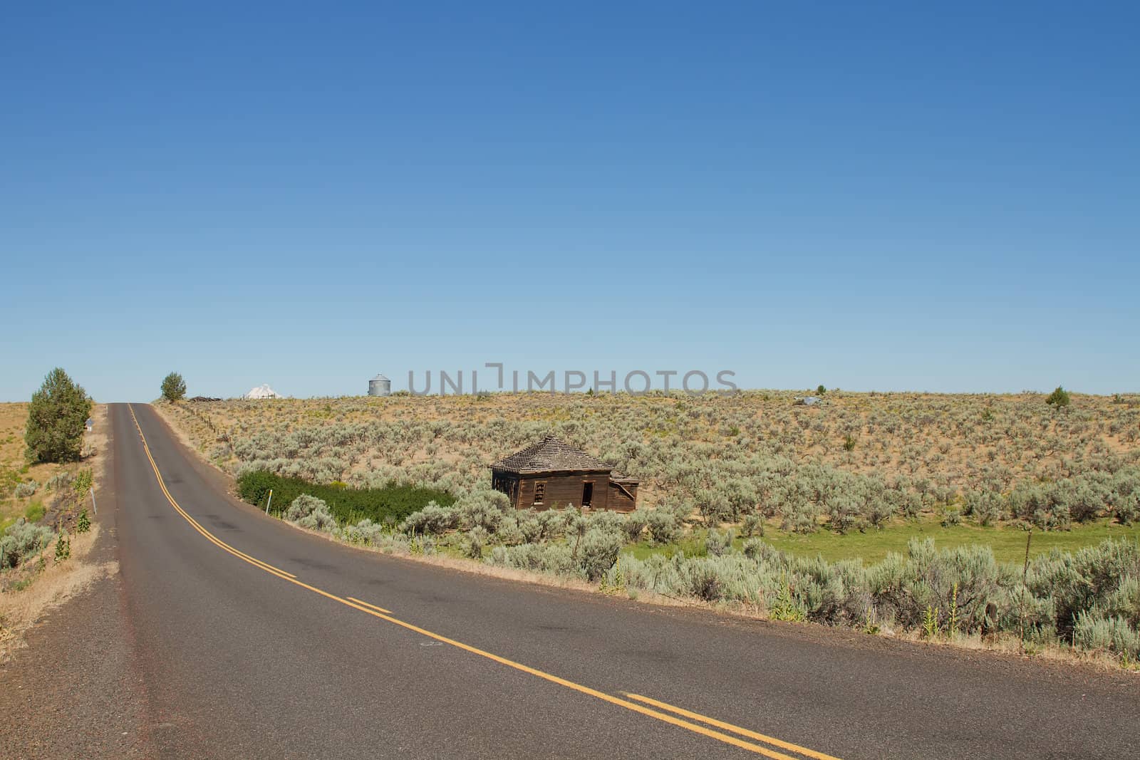 Desert Highway with Abandoned House in Central Oregon