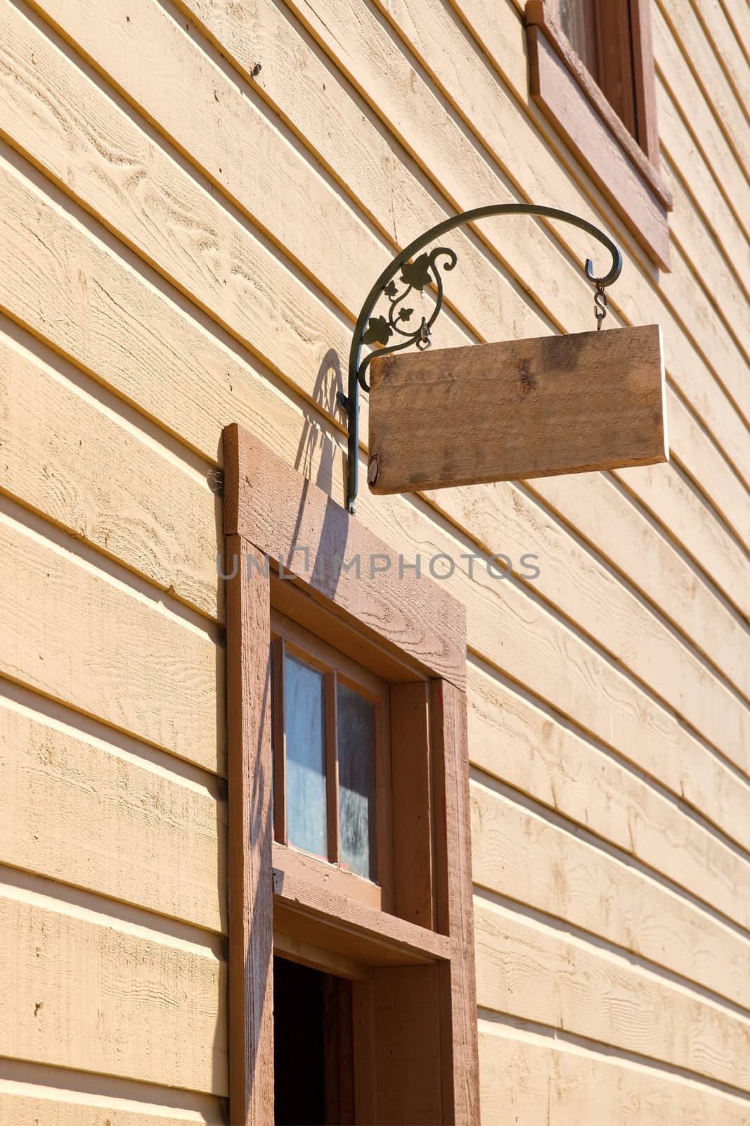 Wood and Rod Iron Signage on Side of Historic Building